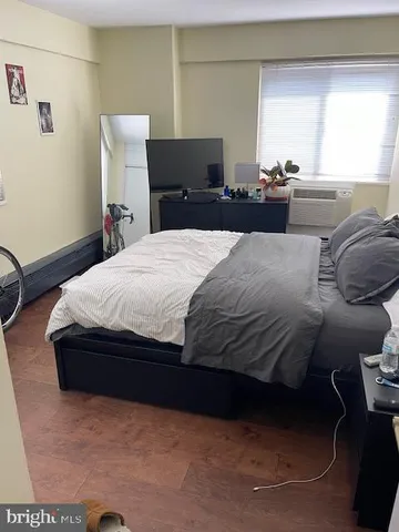 a bedroom with a bed and window