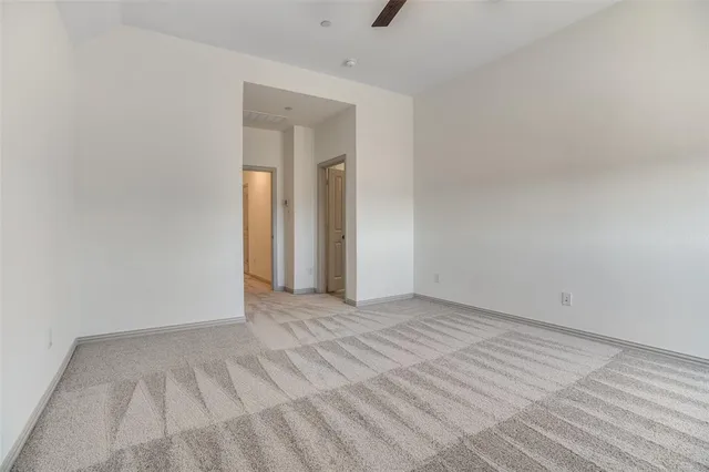 a view of an empty room and wooden floor