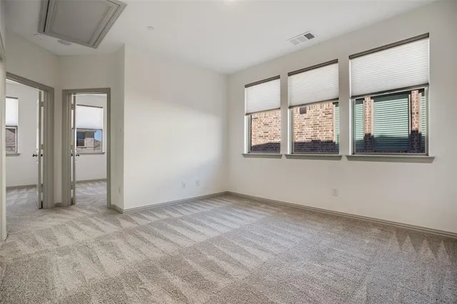 an empty room with windows and closet