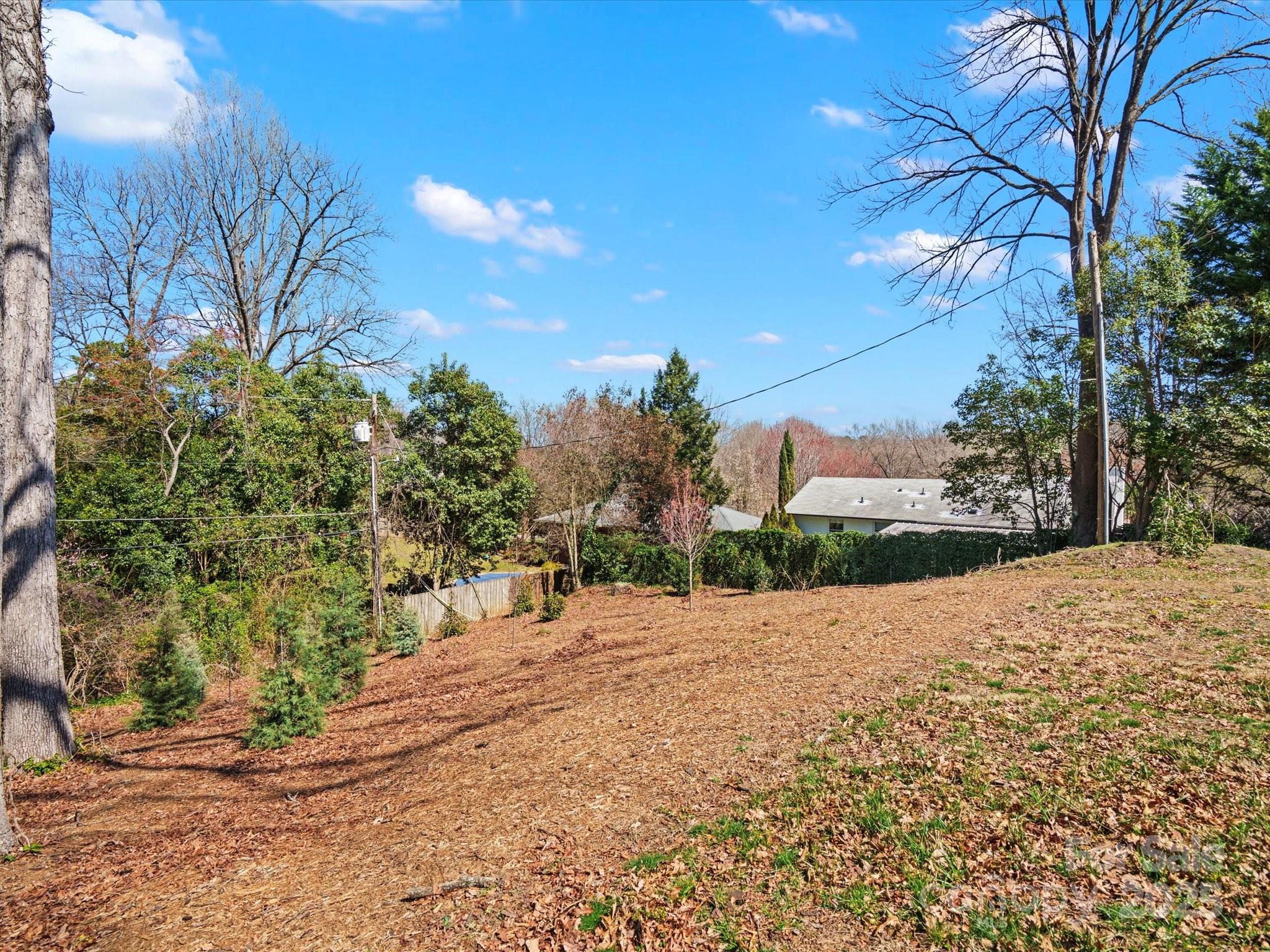 1539 Lilac Road Charlotte, NC 28209 - Photo 5 of 16 a wooden bench with view of trees