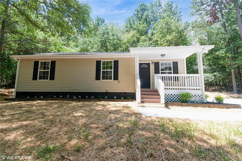 1504 Grady Road Rockmart, GA 30153 - Photo 1 of 1 a view of a house with a backyard