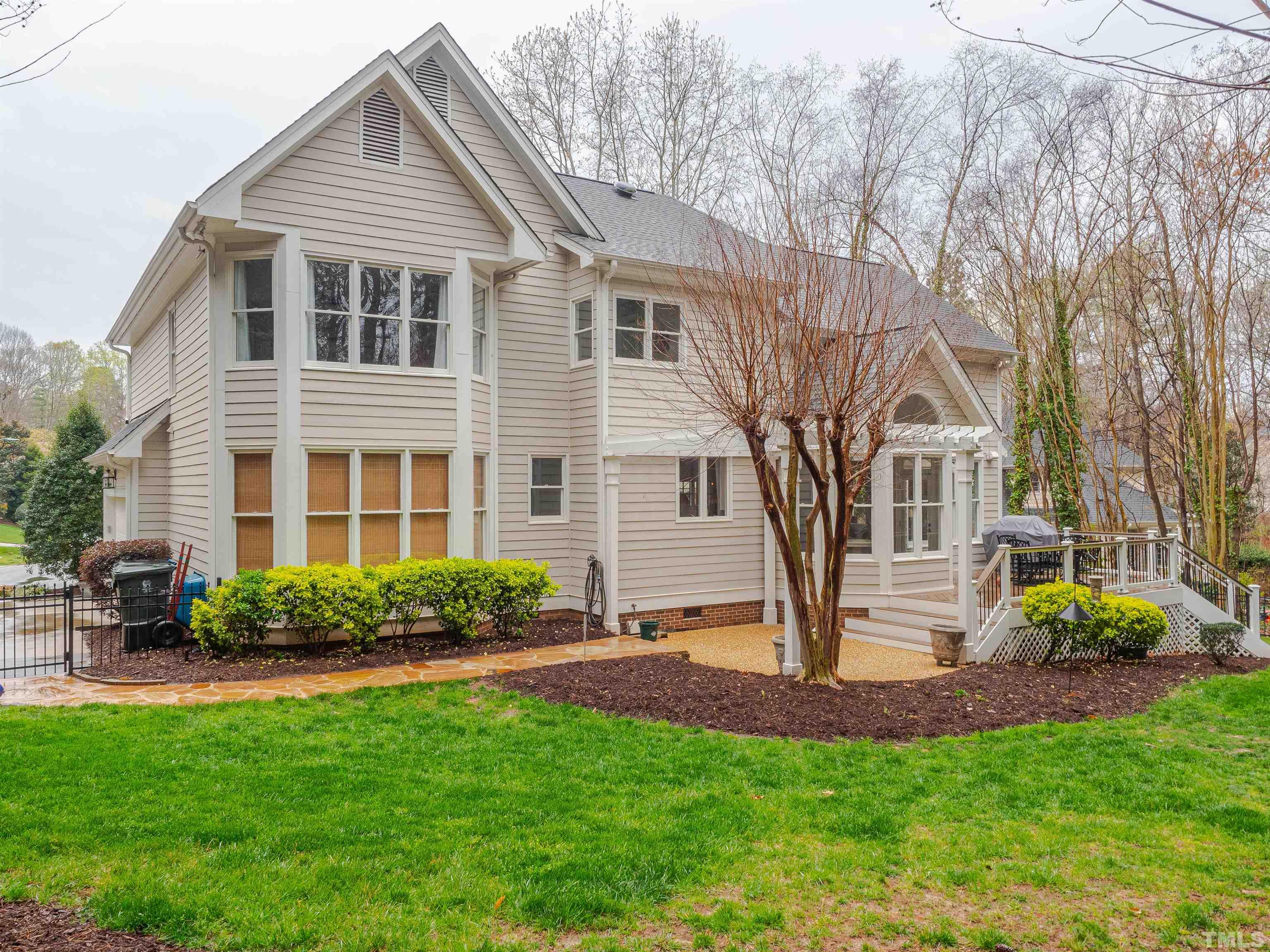 621 Bent Ridge Place Raleigh, NC 27615 - Photo 3 of 36 a front view of a house with garden and trees