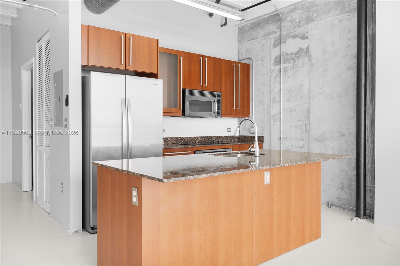 8101 Biscayne Boulevard, Unit R414 Miami, FL 33138 - Photo 13 of 27 a kitchen with stainless steel appliances a refrigerator and a stove