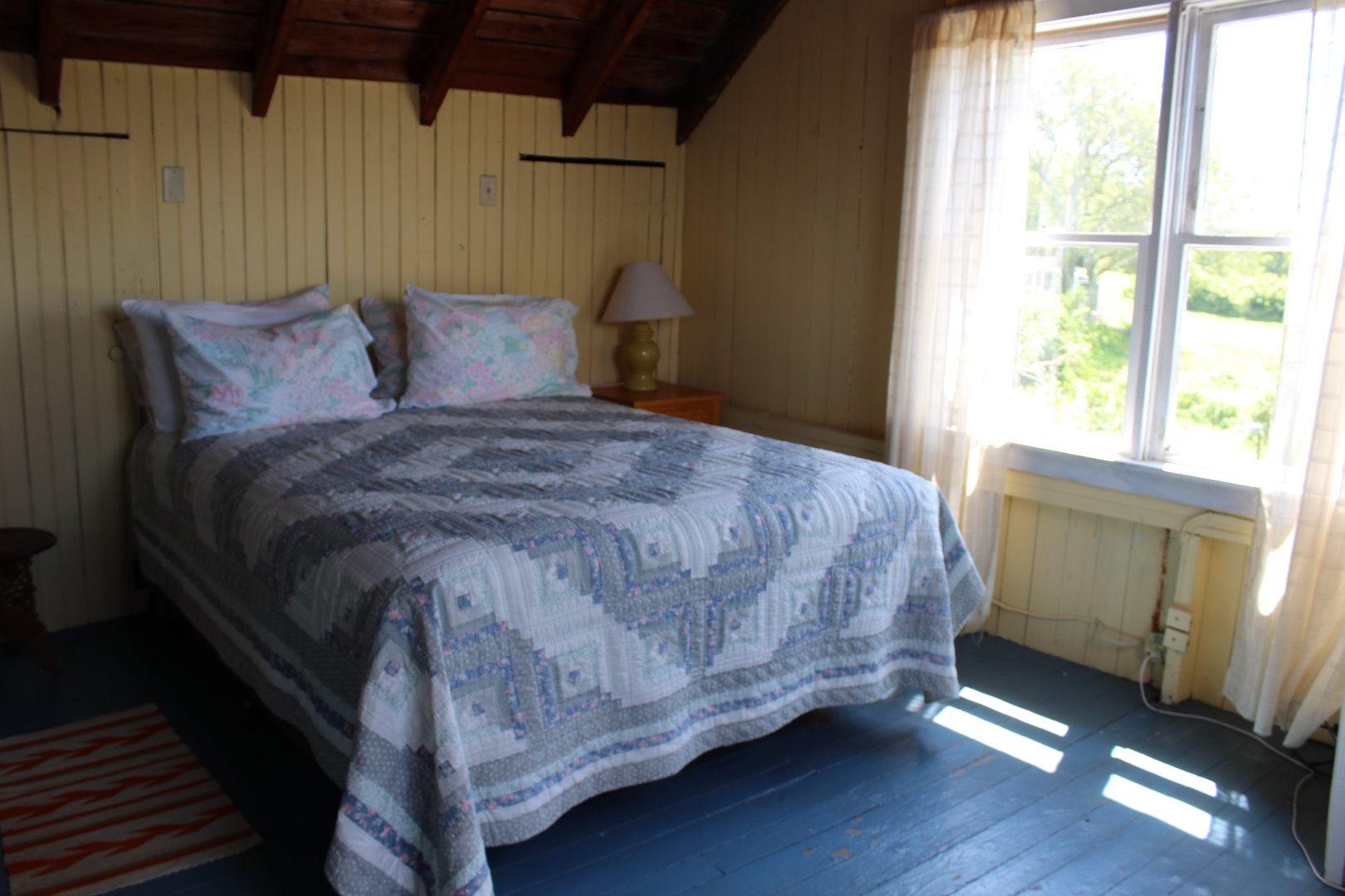 508 N Road Chilmark, MA 02535 - Photo 9 of 10 a bed sitting in a bedroom next to a window