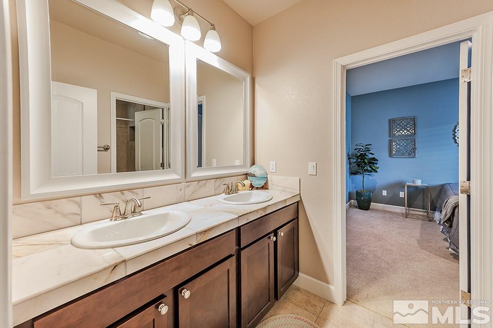 8564 Gypsy Hill Trail Reno, NV 89523 - Photo 13 of 25 a bathroom with a sink double vanity and a mirror