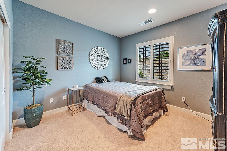 8564 Gypsy Hill Trail Reno, NV 89523 - Photo 14 of 25 a bedroom with a bed and a potted plant