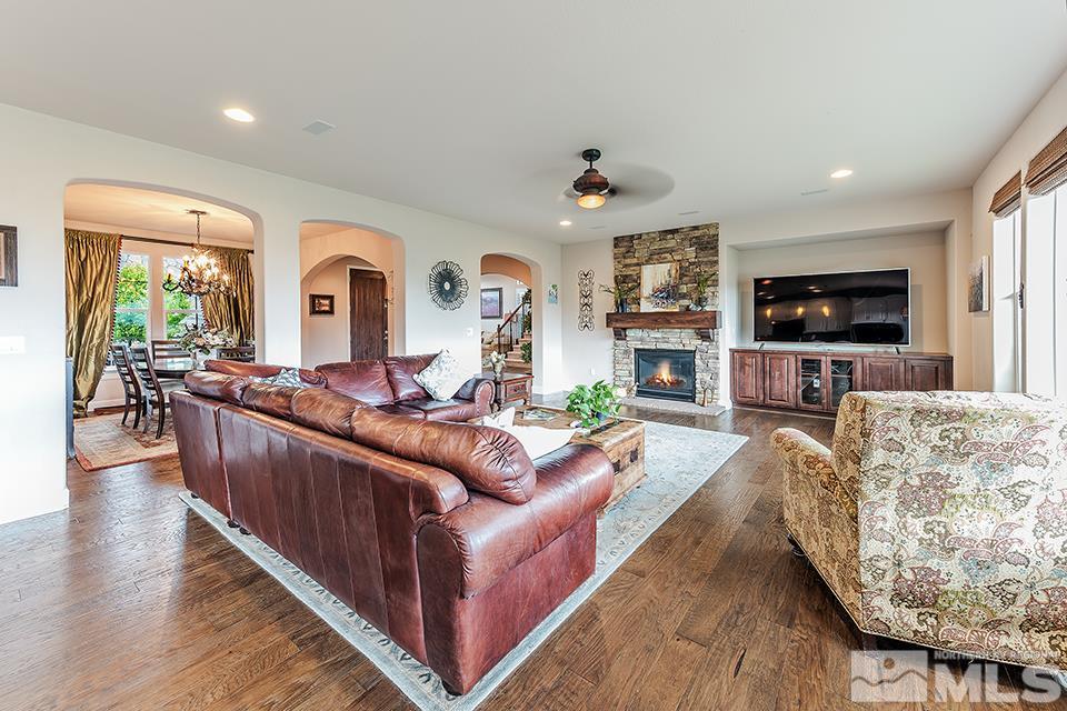 8564 Gypsy Hill Trail Reno, NV 89523 - Photo 18 of 25 a living room with furniture a fireplace and a flat screen tv