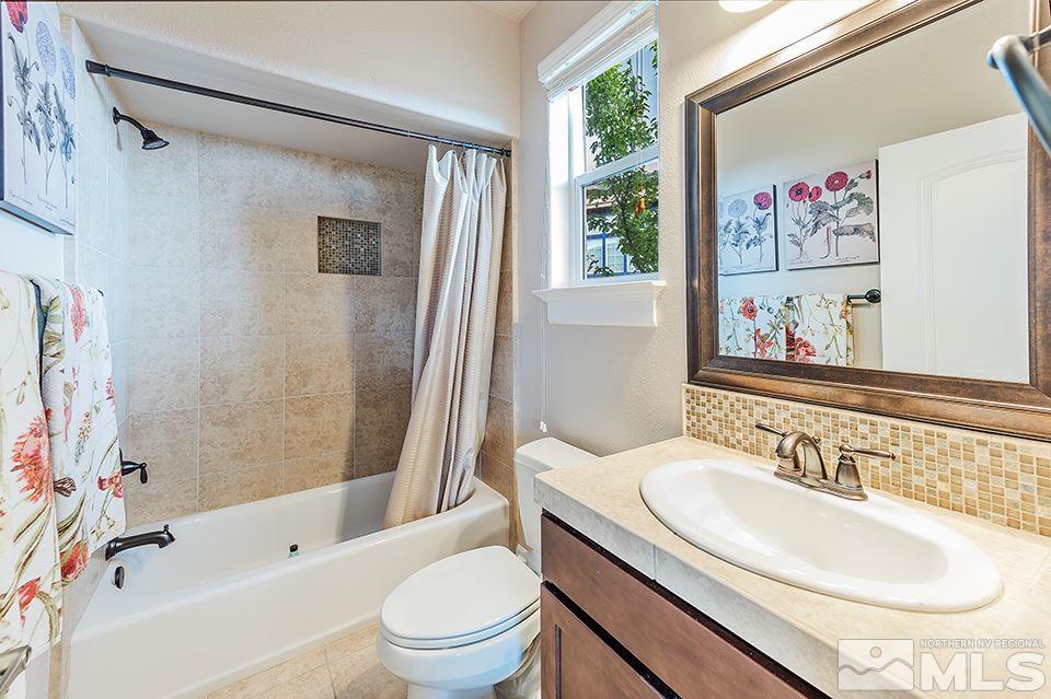 8564 Gypsy Hill Trail Reno, NV 89523 - Photo 7 of 25 a bathroom with a sink toilet and shower