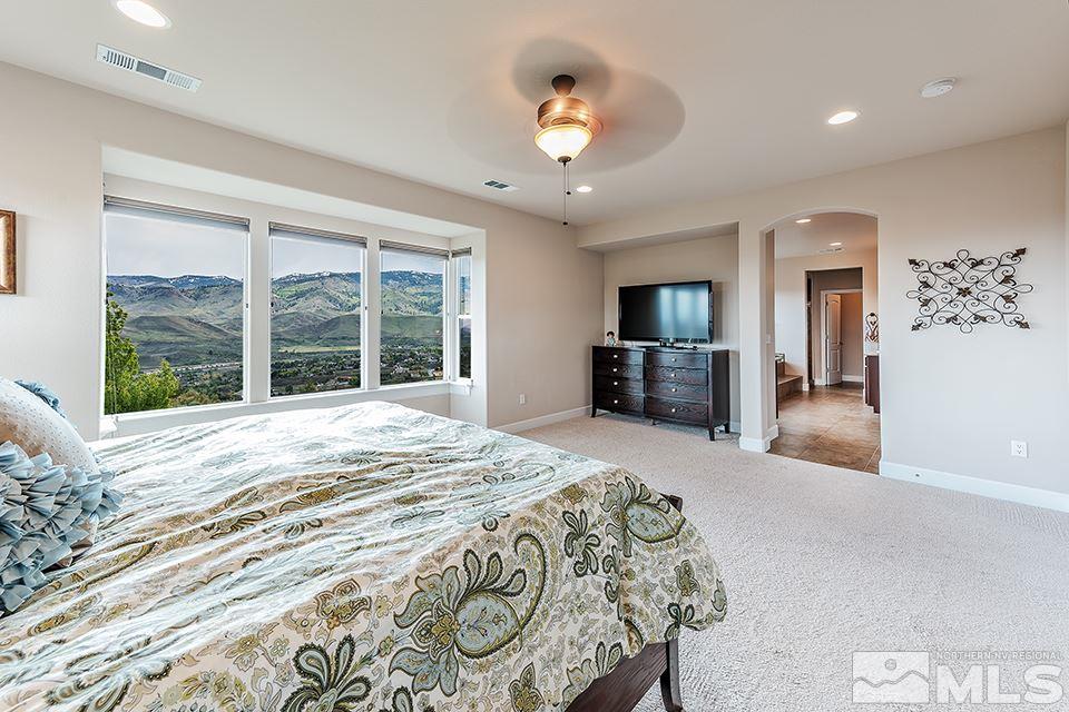 8564 Gypsy Hill Trail Reno, NV 89523 - Photo 9 of 25 a bedroom with a large bed and a large window