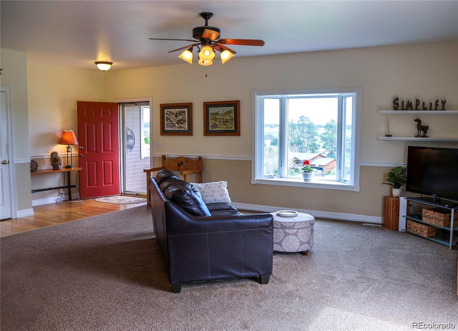 2501 Remington Road Elizabeth, CO 80107 - Photo 23 of 33 a living room with furniture a window and a flat screen tv