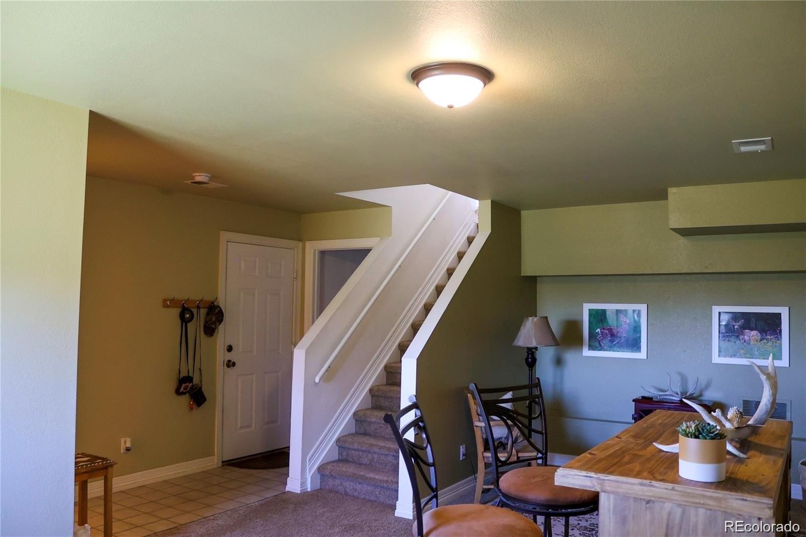 2501 Remington Road Elizabeth, CO 80107 - Photo 31 of 33 a view of a livingroom with furniture and stairs