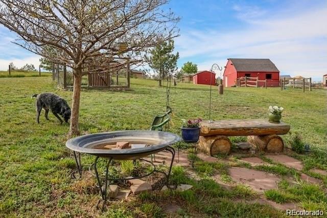 2501 Remington Road Elizabeth, CO 80107 - Photo 9 of 33 a view of a garden with table and chairs