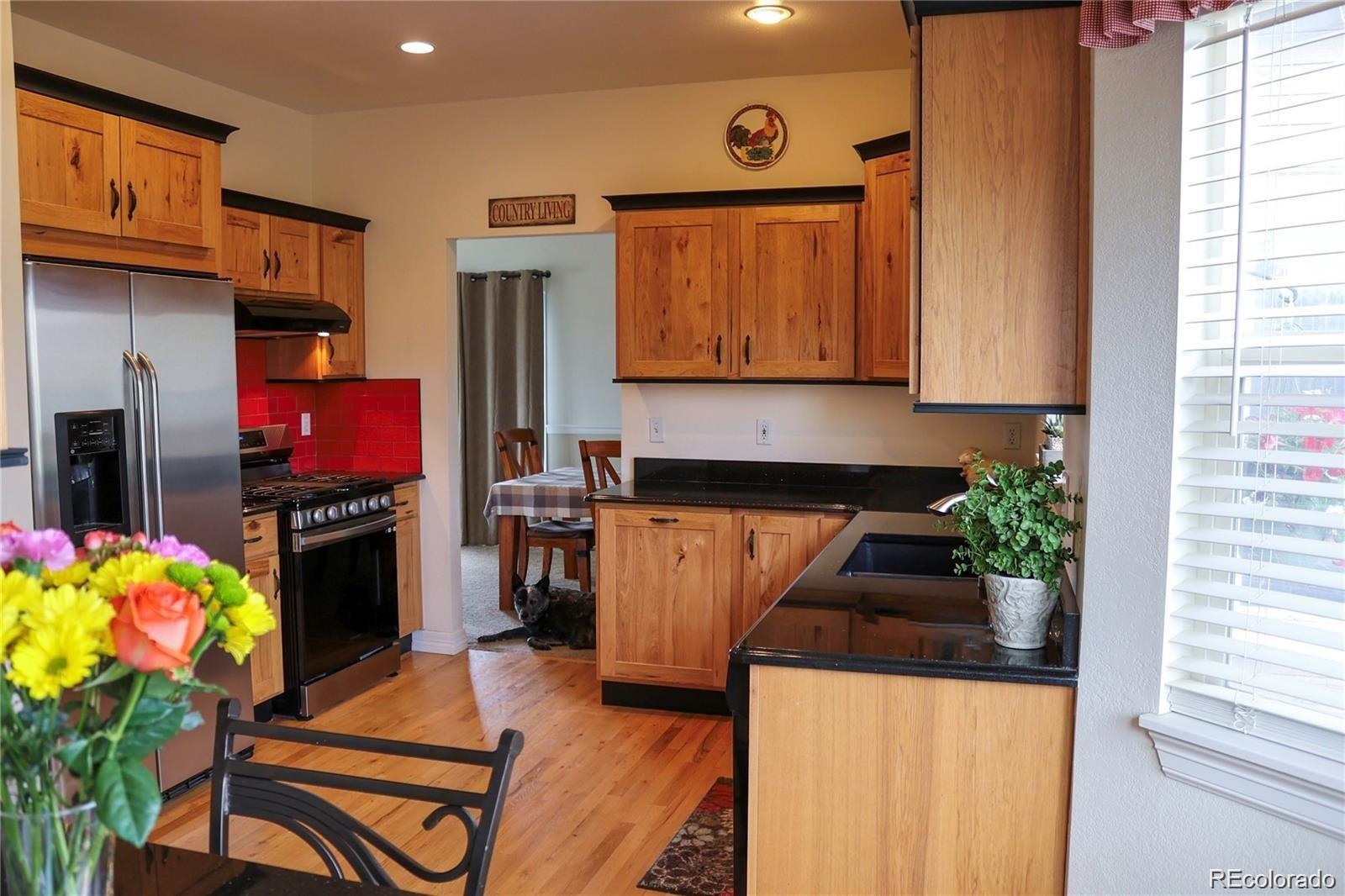 2501 Remington Road Elizabeth, CO 80107 - Photo 10 of 33 a kitchen with stainless steel appliances granite countertop a stove a refrigerator and a microwave
