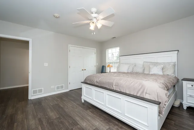 a bedroom with a large bed and a chandelier