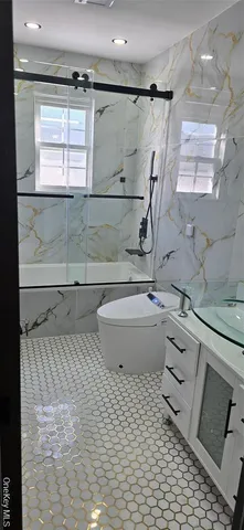 a bathroom with a sink toilet a mirror and window
