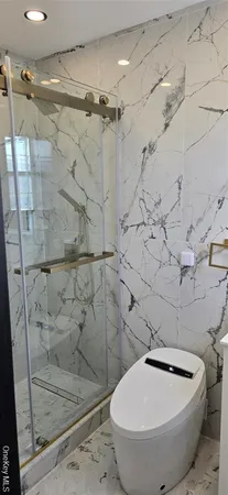 a bathroom with a white bath tub and a shower
