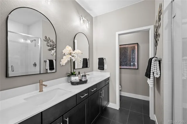 a bathroom with a double vanity sink and a mirror