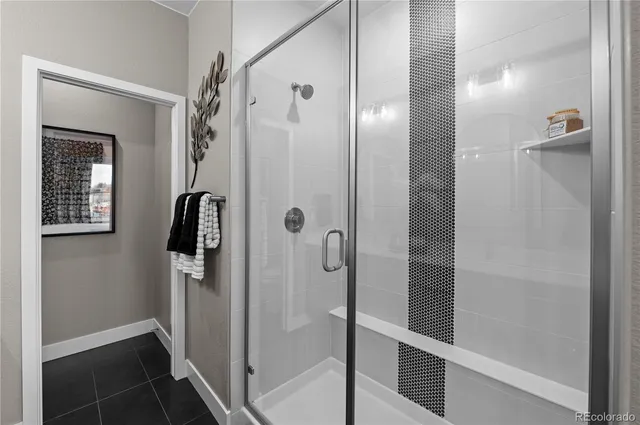a bathroom with a glass shower door
