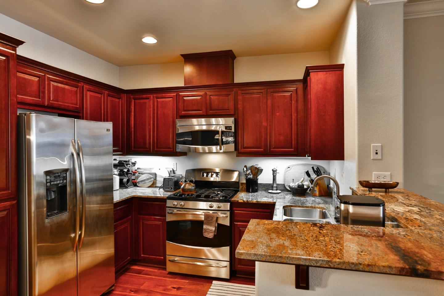 3465 Dublin Boulevard, Unit 111 Dublin, CA 94568 - Photo 3 of 21 a kitchen with stainless steel appliances granite countertop a refrigerator a stove top oven a sink and dishwasher