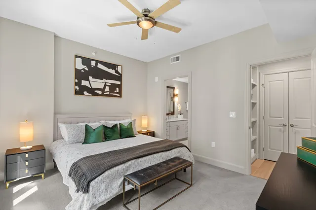 a bedroom with a bed and a chandelier