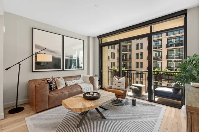a living room with furniture and a floor to ceiling window
