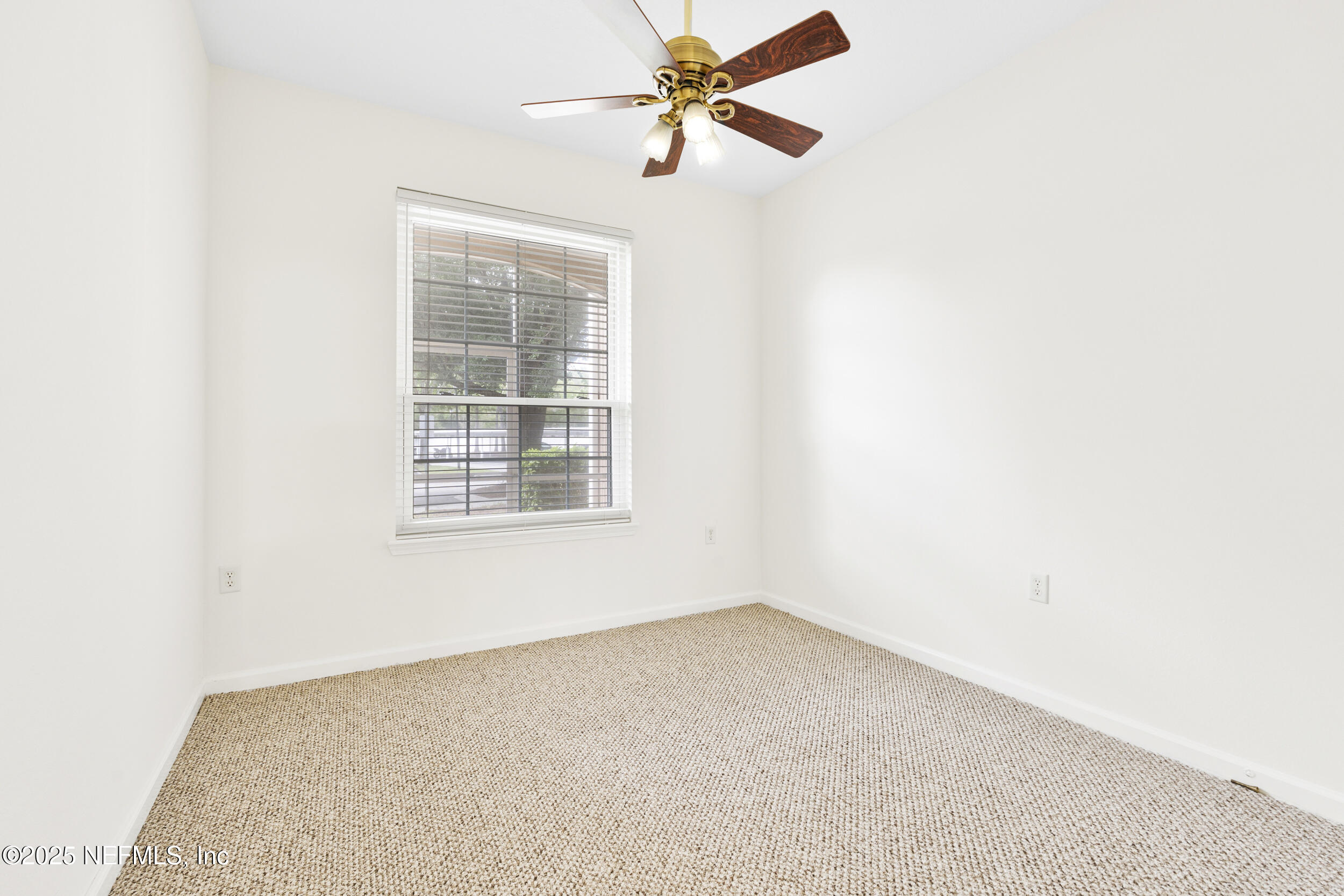 7990 Baymeadows Road East, Unit 120 Jacksonville, FL 32256 - Photo 20 of 38 an empty room with a window and a fan