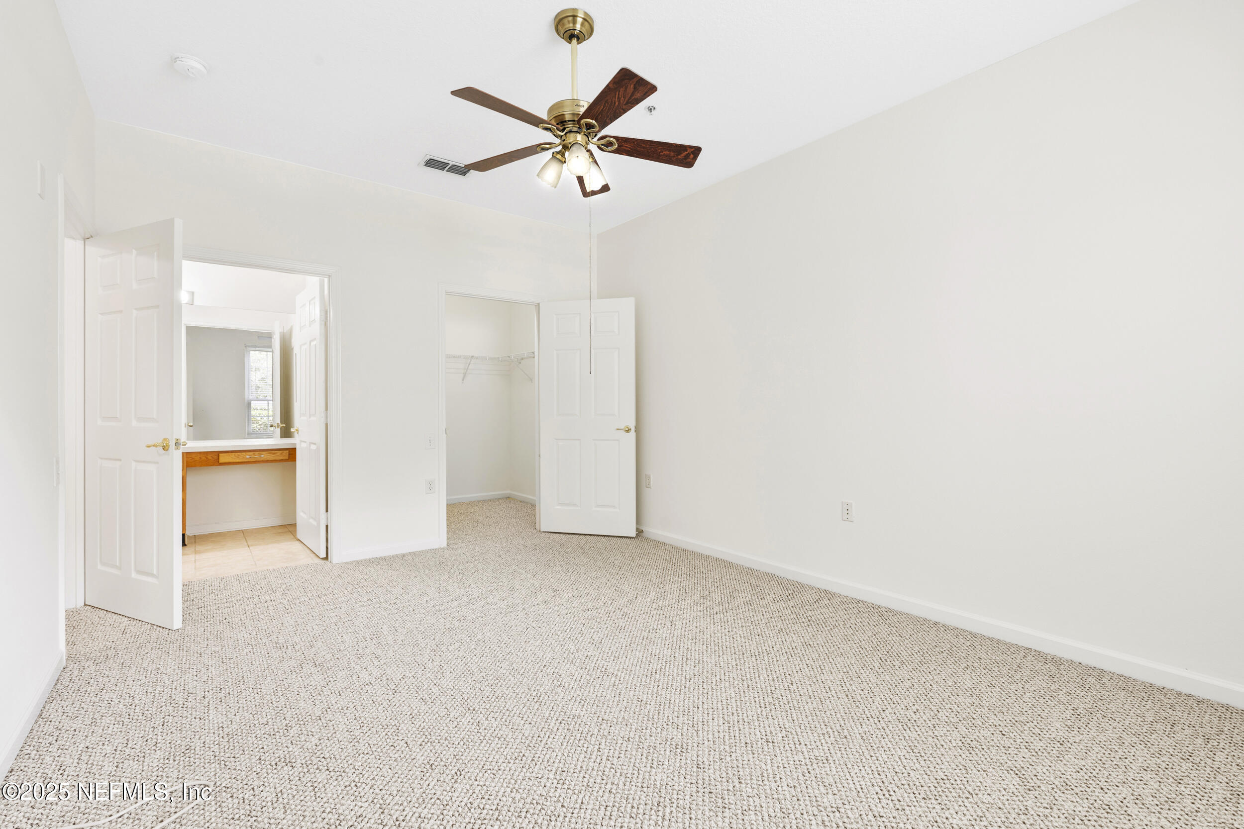 7990 Baymeadows Road East, Unit 120 Jacksonville, FL 32256 - Photo 23 of 38 an empty room with closet and a chandelier fan