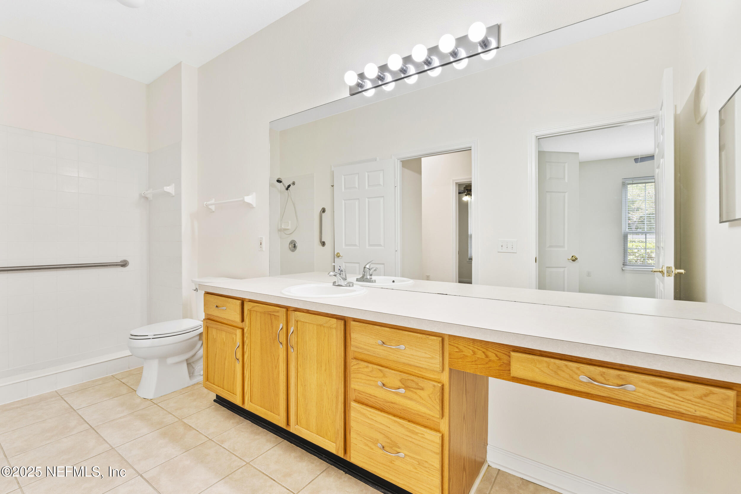 7990 Baymeadows Road East, Unit 120 Jacksonville, FL 32256 - Photo 25 of 38 a spacious bathroom with a granite countertop sink mirror and toilet