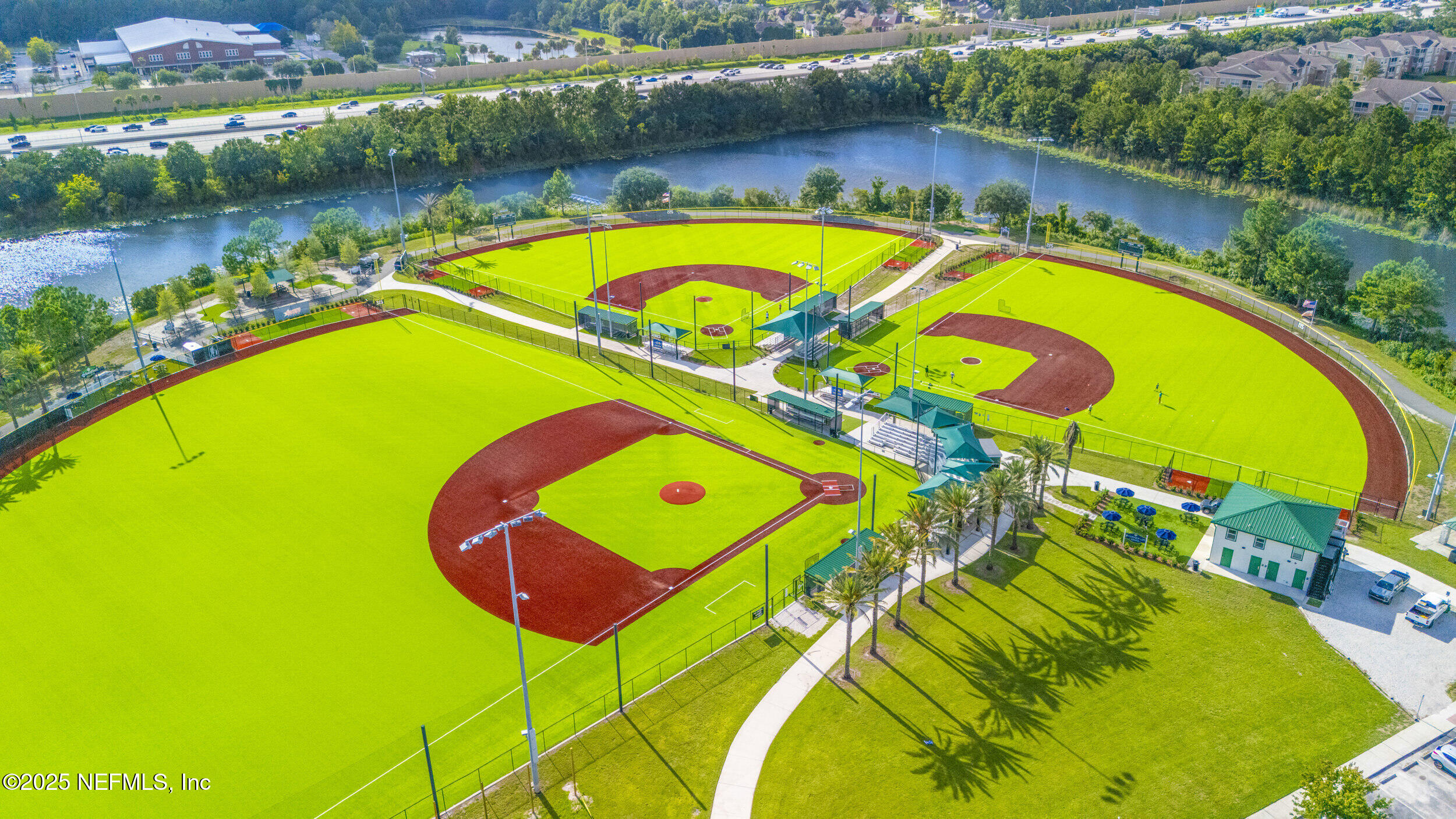7990 Baymeadows Road East, Unit 120 Jacksonville, FL 32256 - Photo 34 of 38 an aerial view of a swimming pool with a yard and outdoor seating