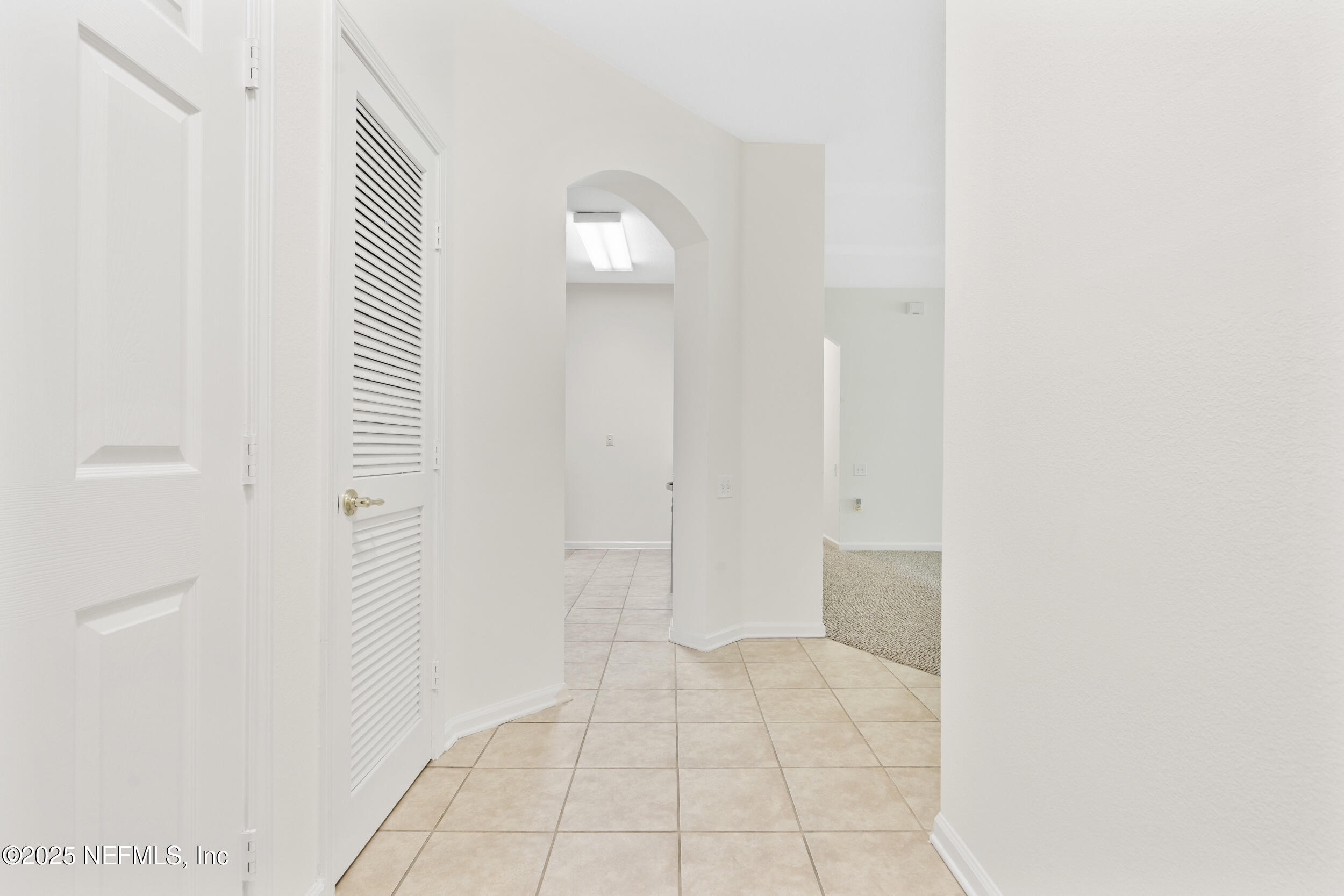 7990 Baymeadows Road East, Unit 120 Jacksonville, FL 32256 - Photo 5 of 38 a view of an empty room with wooden floor and a bathroom