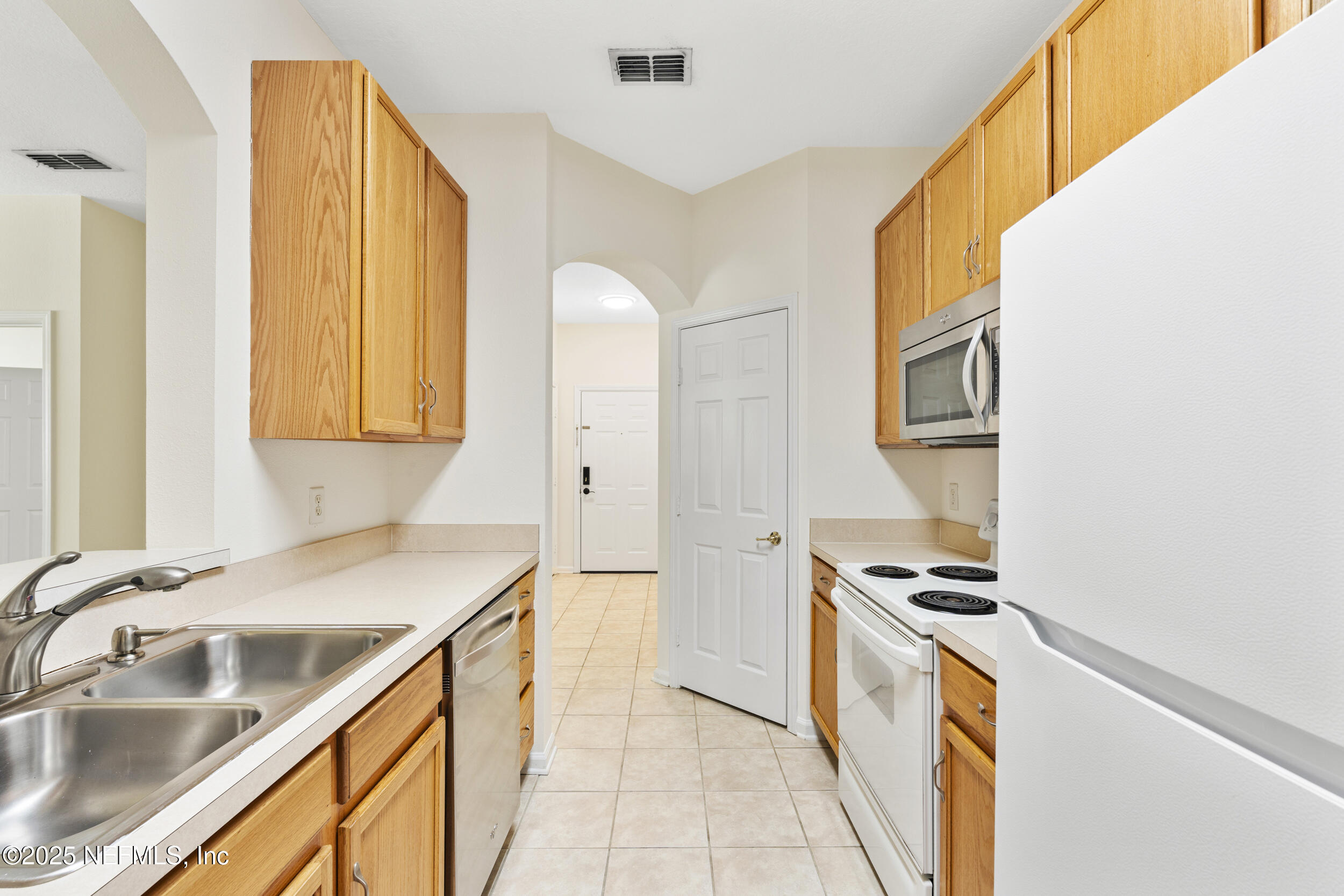 7990 Baymeadows Road East, Unit 120 Jacksonville, FL 32256 - Photo 6 of 38 a kitchen with stainless steel appliances a sink a stove and a refrigerator