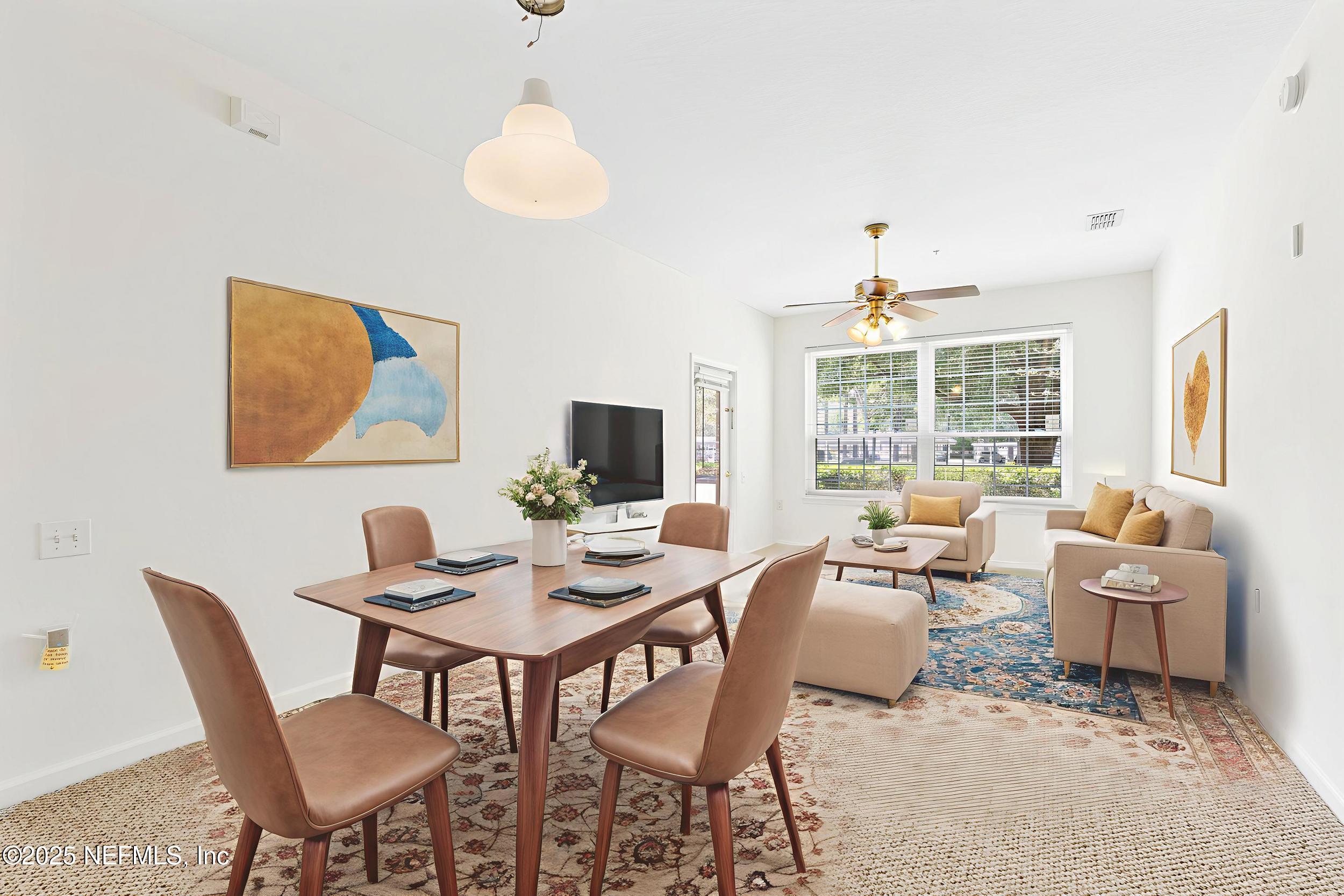 7990 Baymeadows Road East, Unit 120 Jacksonville, FL 32256 - Photo 9 of 38 a living room with furniture a flat screen tv and a large window
