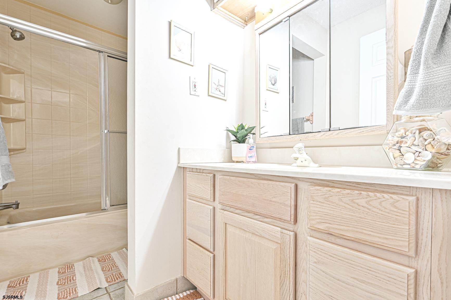 400 East Brigantine Avenue, Unit 2C Brigantine, NJ 08203 - Photo 11 of 37 a bathroom with a sink and a mirror
