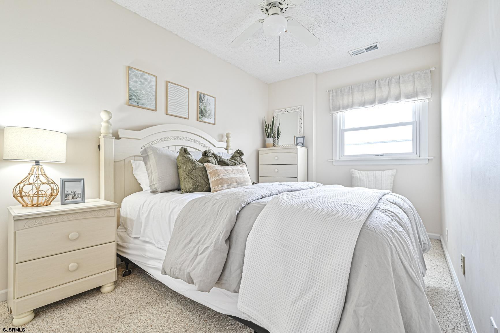 400 East Brigantine Avenue, Unit 2C Brigantine, NJ 08203 - Photo 12 of 37 a bedroom with a bed and a window