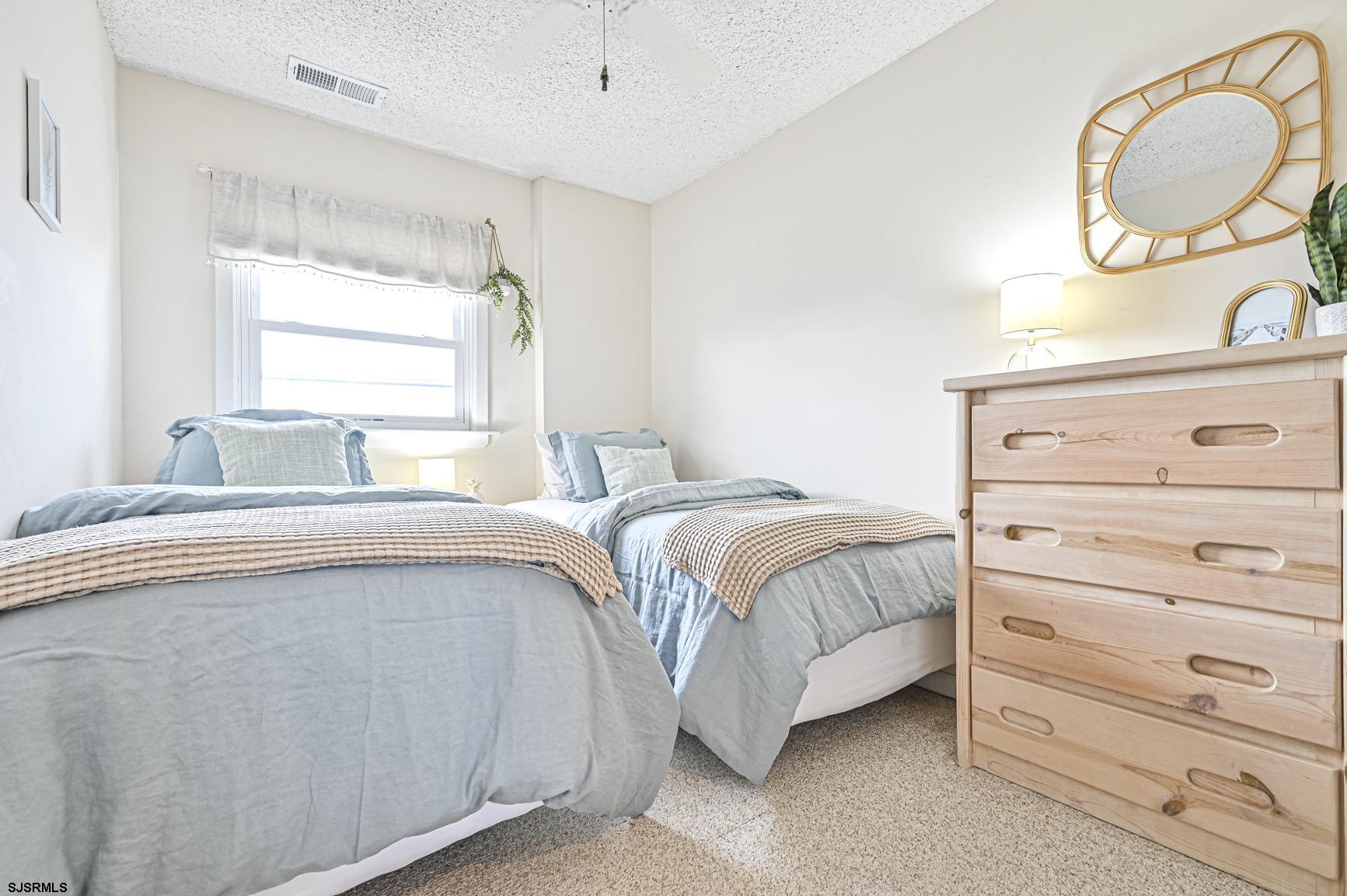 400 East Brigantine Avenue, Unit 2C Brigantine, NJ 08203 - Photo 13 of 37 a bedroom with a bed and a dresser