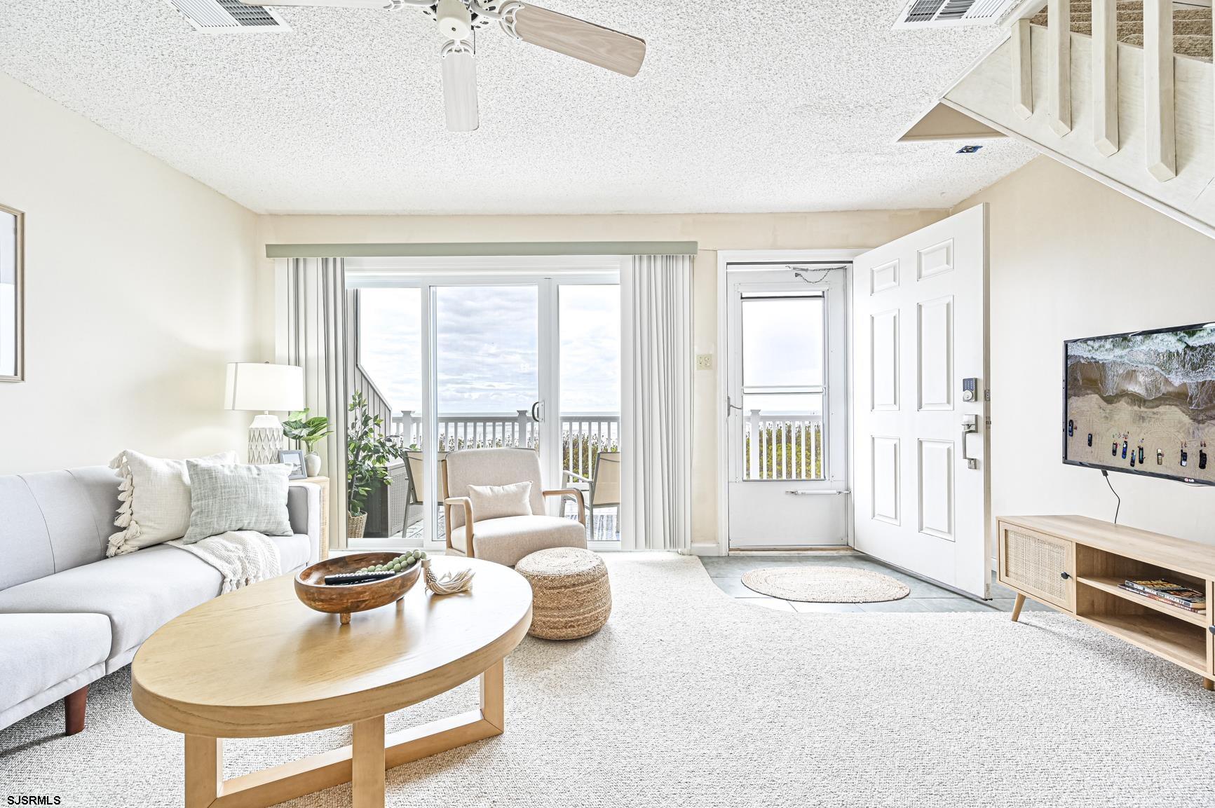 400 East Brigantine Avenue, Unit 2C Brigantine, NJ 08203 - Photo 3 of 37 a living room with furniture and a floor to ceiling window
