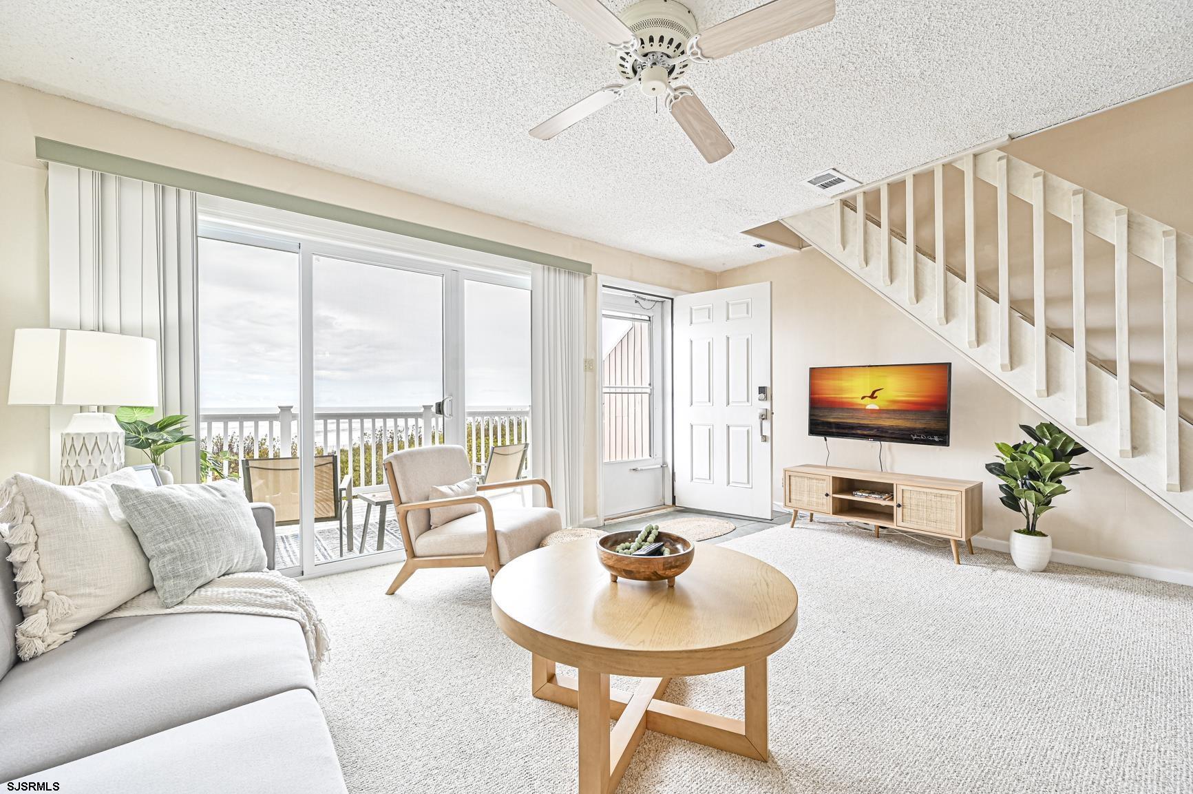 400 East Brigantine Avenue, Unit 2C Brigantine, NJ 08203 - Photo 4 of 37 a living room with furniture and a flat screen tv