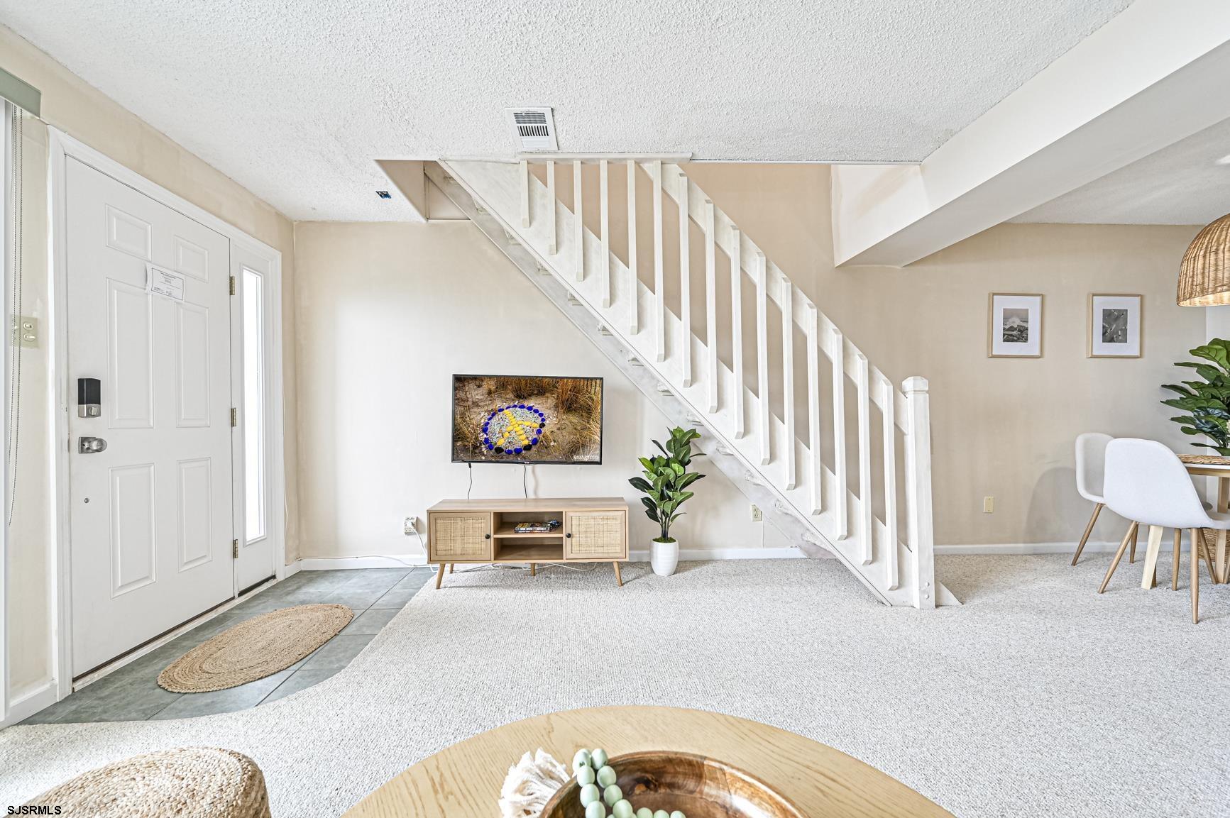400 East Brigantine Avenue, Unit 2C Brigantine, NJ 08203 - Photo 6 of 37 a view of a livingroom with furniture and stairs