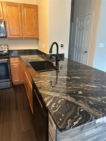 a kitchen with a sink stove and cabinets