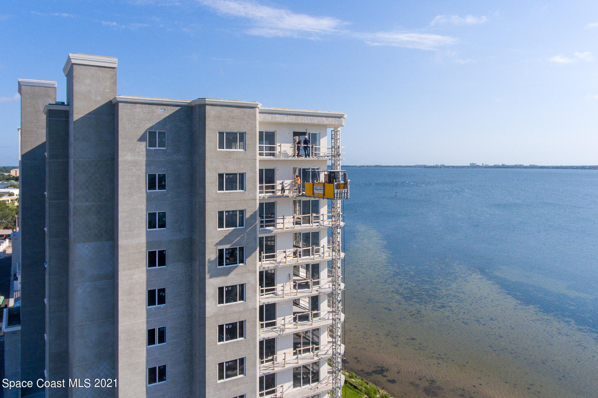1465 South Harbor City Boulevard, Unit 404 Melbourne, FL 32901 - Photo 11 of 55 a view of a tall building next to a blue wall