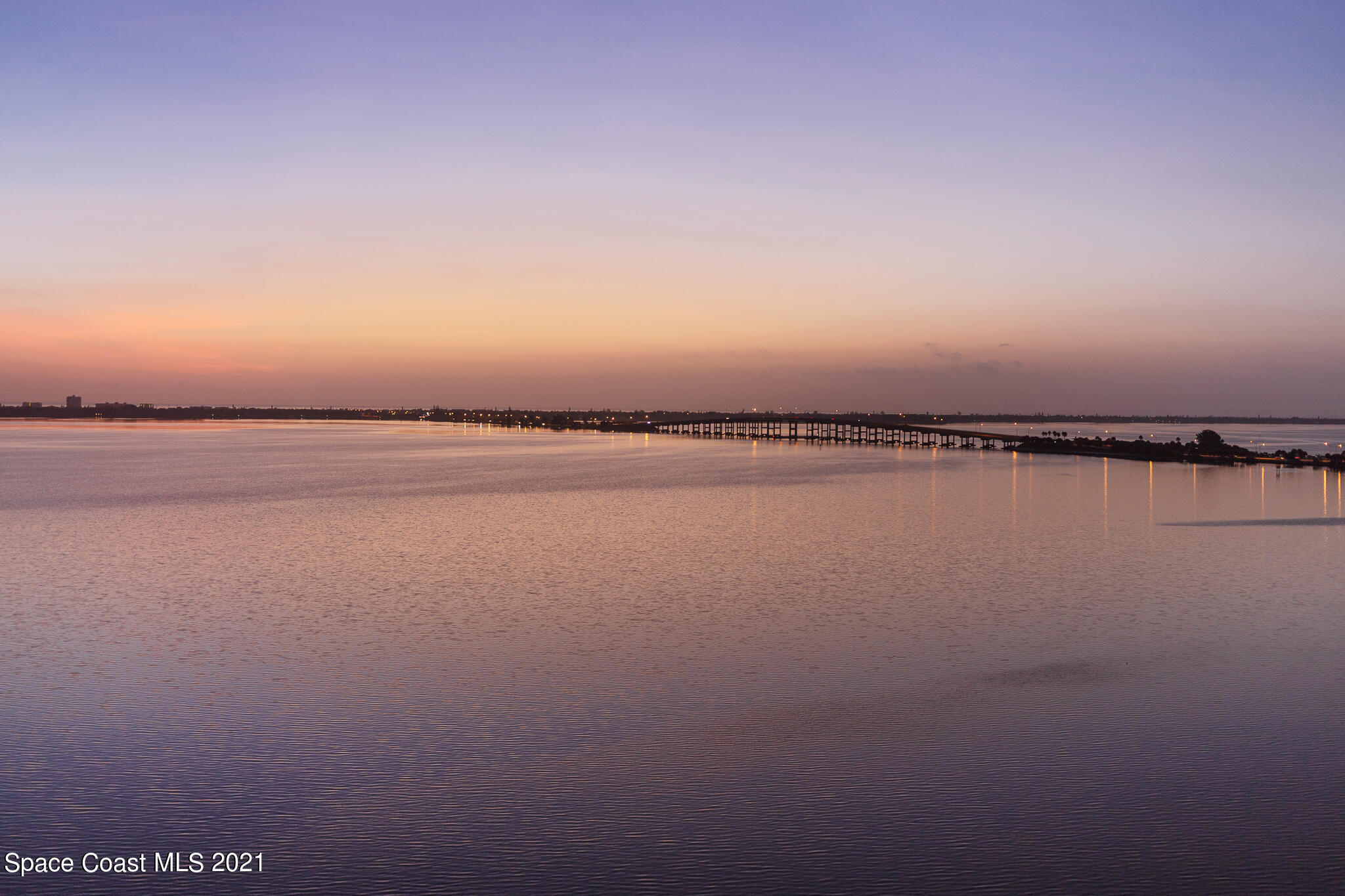 1465 South Harbor City Boulevard, Unit 404 Melbourne, FL 32901 - Photo 13 of 55 a view of a lake and sunset