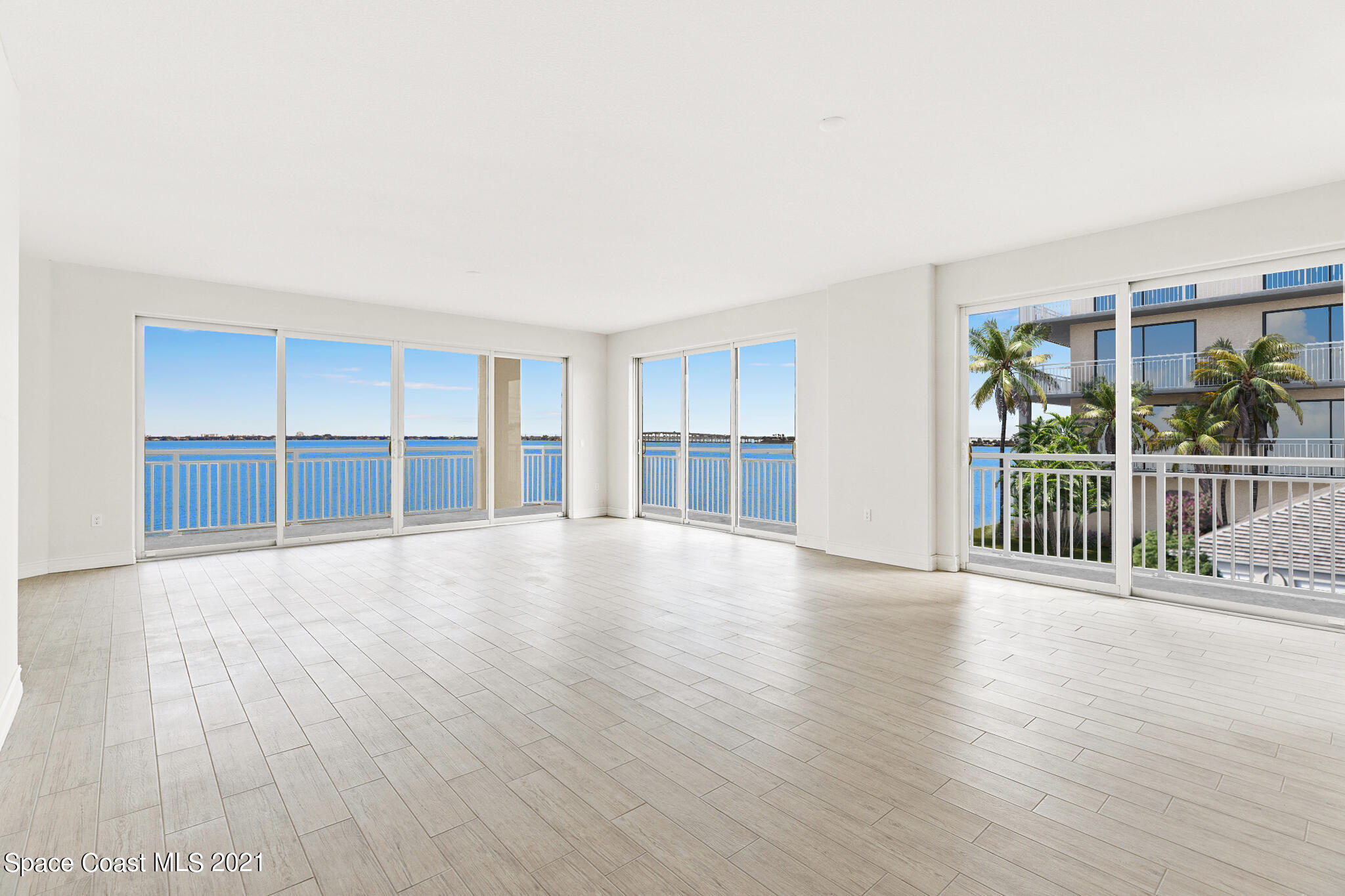 1465 South Harbor City Boulevard, Unit 404 Melbourne, FL 32901 - Photo 15 of 55 a view of an empty room with a window and wooden floor