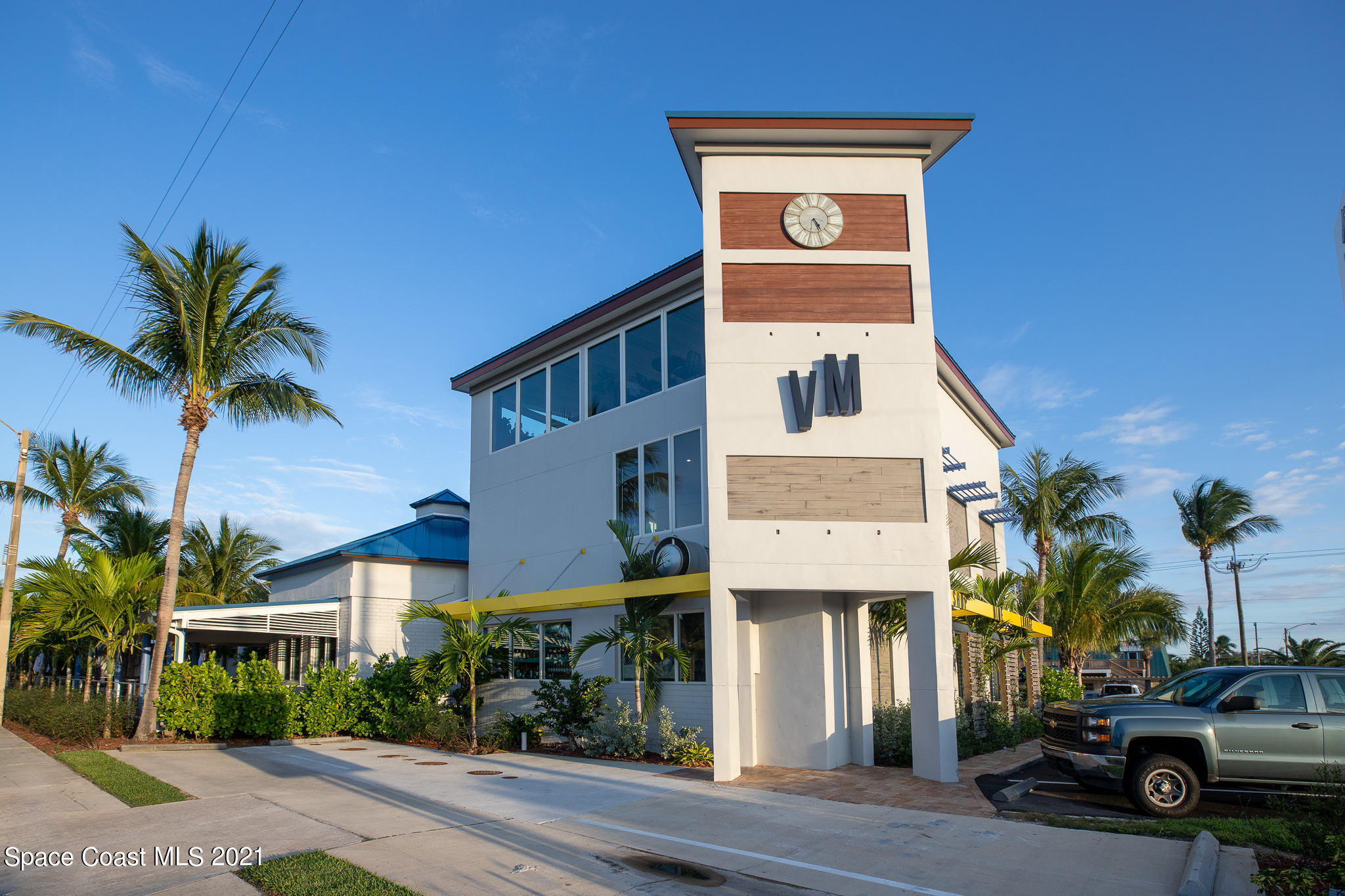 1465 South Harbor City Boulevard, Unit 404 Melbourne, FL 32901 - Photo 31 of 55 a front view of a building with a garden and a garage