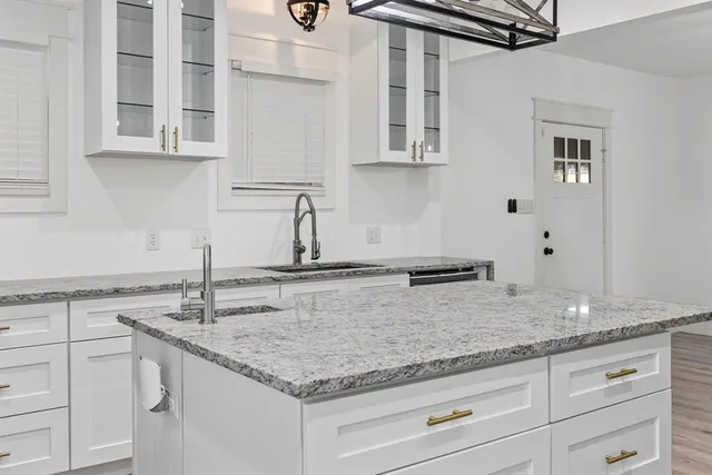 a kitchen with stainless steel appliances granite countertop a sink and cabinets