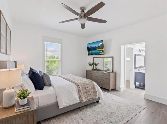 a bedroom with a bed a couch and a window