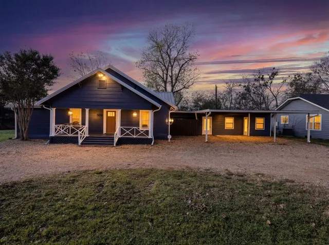 a view of a house with a yard and garage