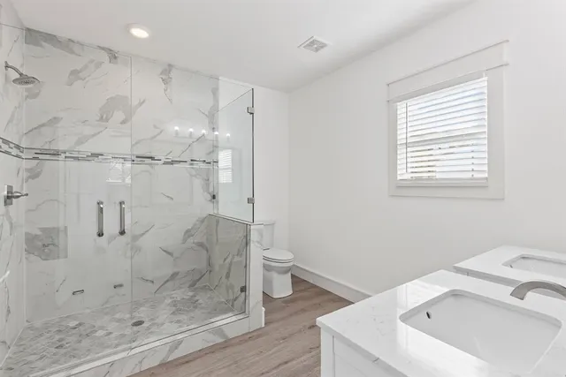 a bathroom with a sink toilet and shower