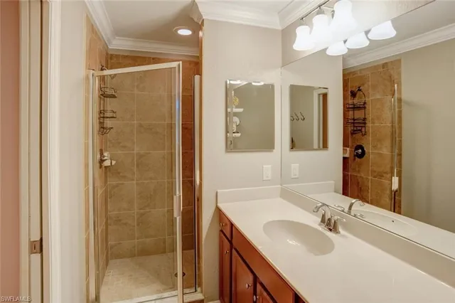 a bathroom with a shower sink vanity granite and mirror