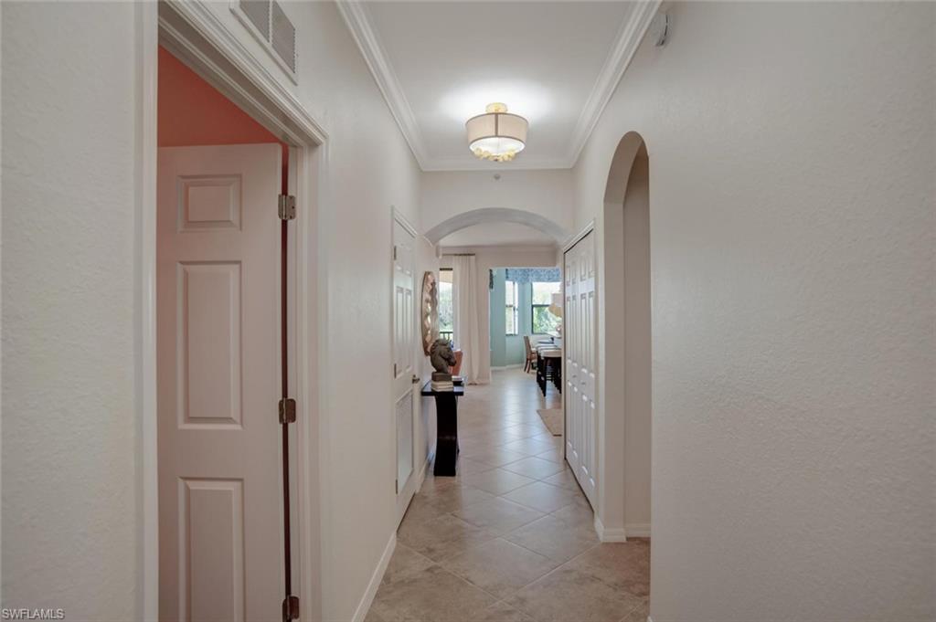 9731 Acqua Court, Unit 523 Naples, FL 34113 - Photo 4 of 27 a view of a hallway with living room and furniture