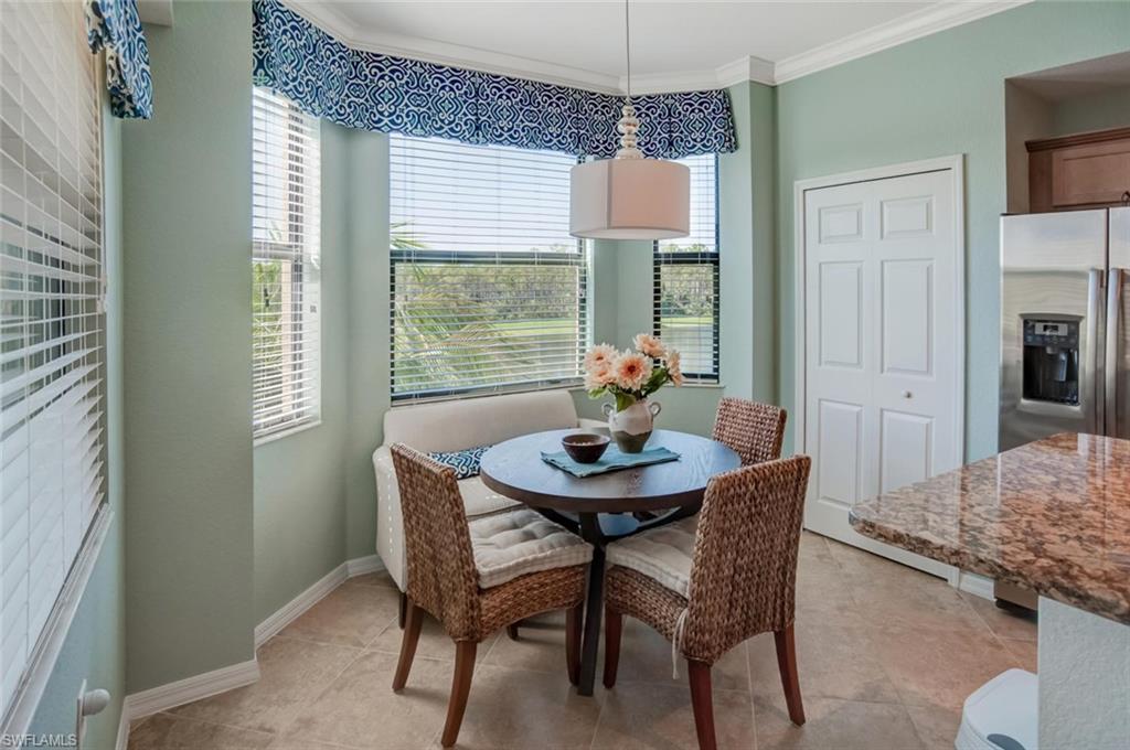 9731 Acqua Court, Unit 523 Naples, FL 34113 - Photo 10 of 27 a view of a dining room with furniture window and outside view